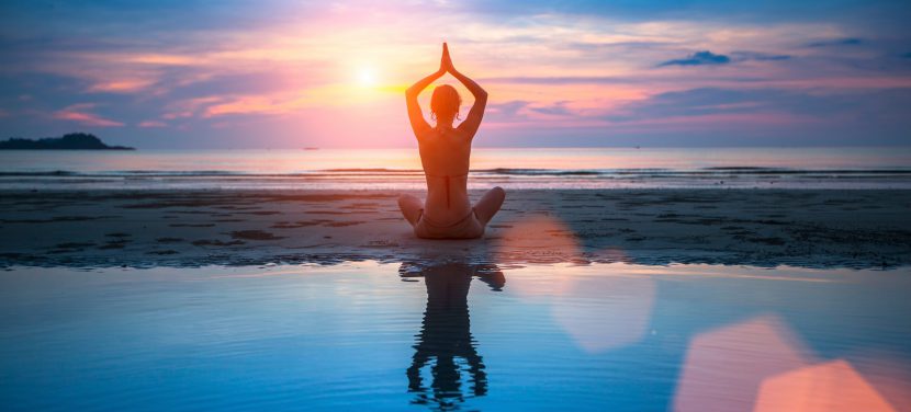 Yoga, silhouette of meditating woman.